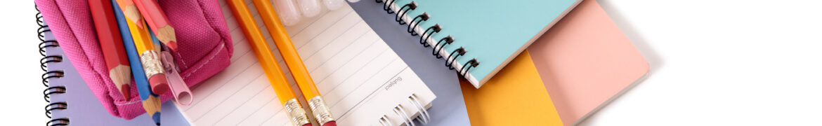 Various school supplies including notebooks, calculator and pink pencil case isolated against a white background